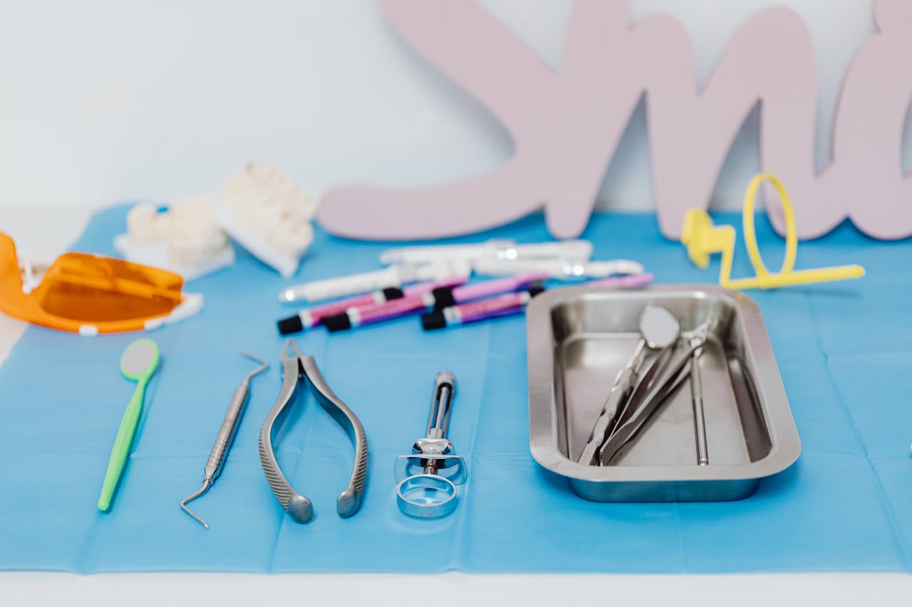 why-choose-us A set of dental tools neatly arranged on a blue mat, emphasizing modern dentistry.